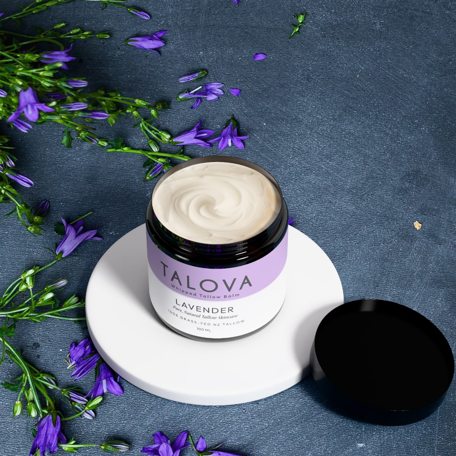 Talova lavender whipped tallow balm 100ml open jar with lavender flowers moody background