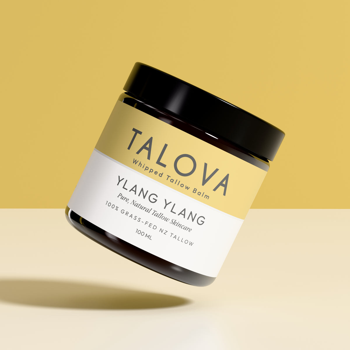 Talova Ylang Ylang whipped tallow balm jar on a yellow background